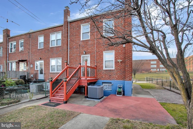 rear view of property with cooling unit