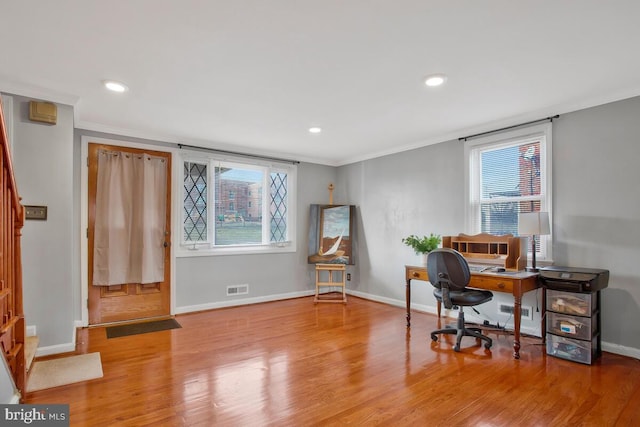 home office with plenty of natural light, light wood-type flooring, and crown molding