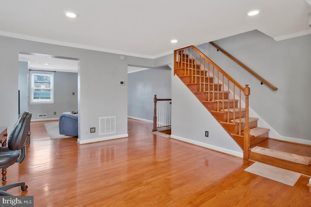 interior space with hardwood / wood-style floors and crown molding