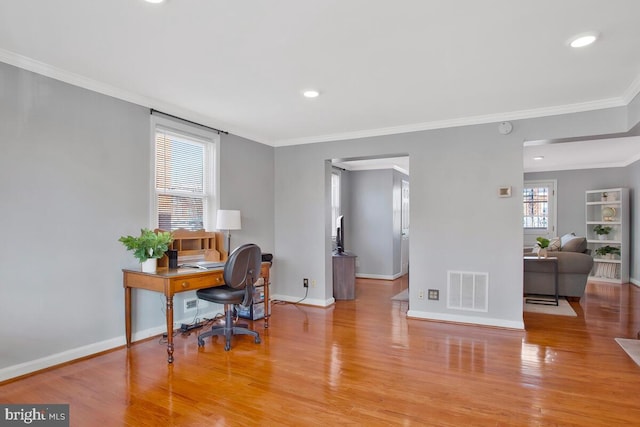 office area with crown molding and light hardwood / wood-style flooring