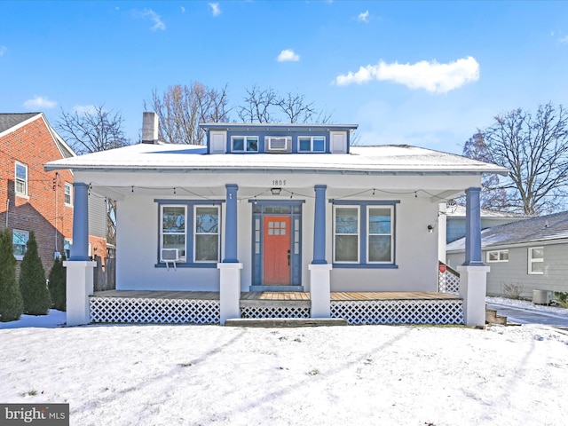 view of front facade featuring cooling unit and a porch