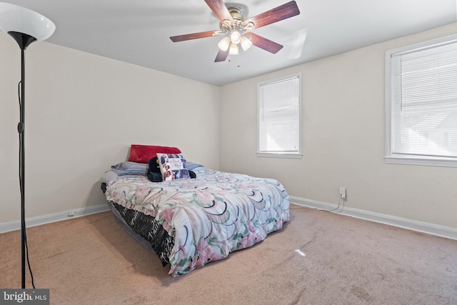 bedroom featuring carpet flooring, multiple windows, and ceiling fan