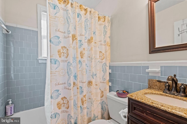 full bathroom with shower / bath combo, vanity, toilet, and tile walls