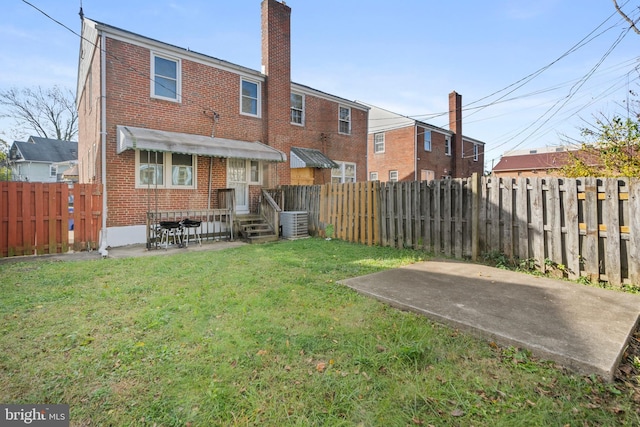 back of property featuring a lawn, a patio, a wooden deck, and central AC