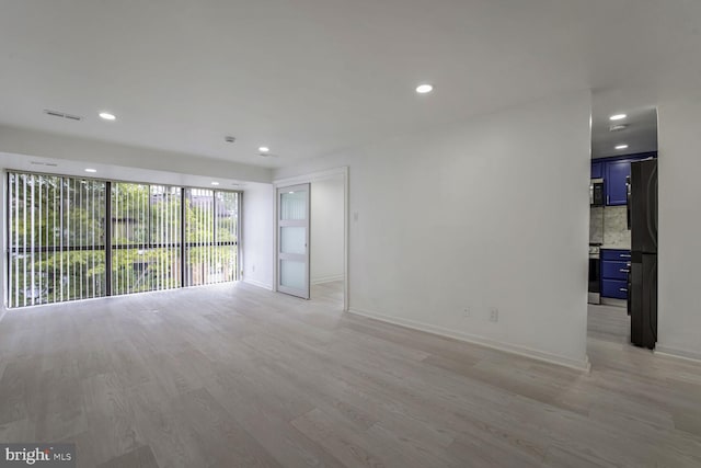 unfurnished room with light hardwood / wood-style flooring