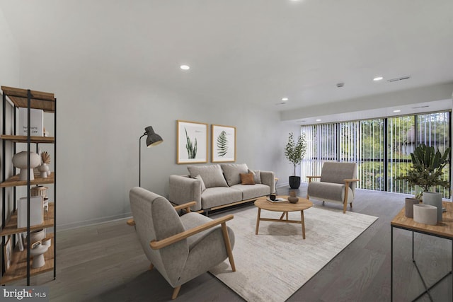 living room with floor to ceiling windows and dark hardwood / wood-style floors