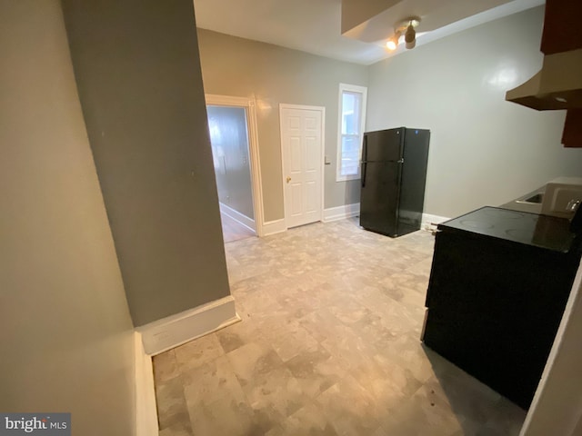 kitchen featuring black fridge and extractor fan