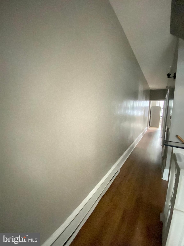 hall with dark hardwood / wood-style floors and vaulted ceiling