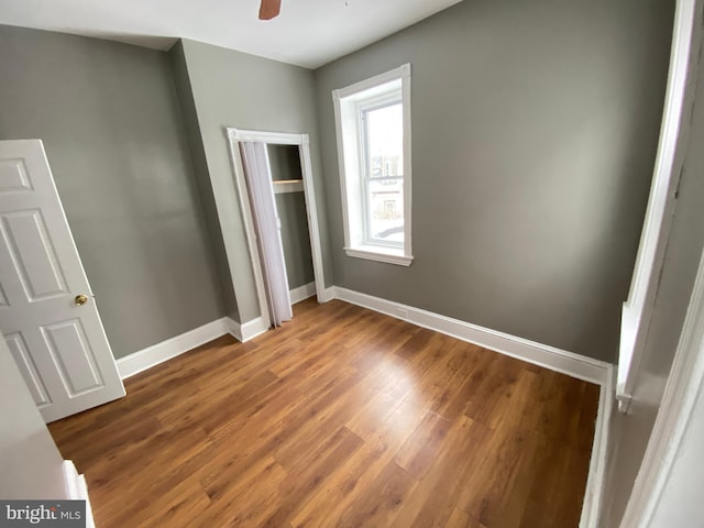 unfurnished bedroom with hardwood / wood-style flooring and ceiling fan