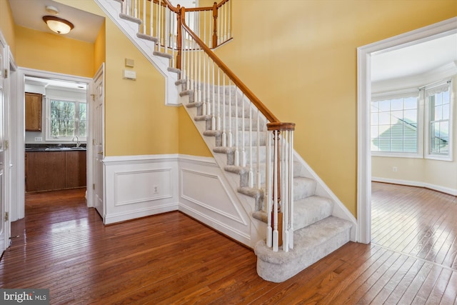 stairway featuring hardwood / wood-style flooring and sink