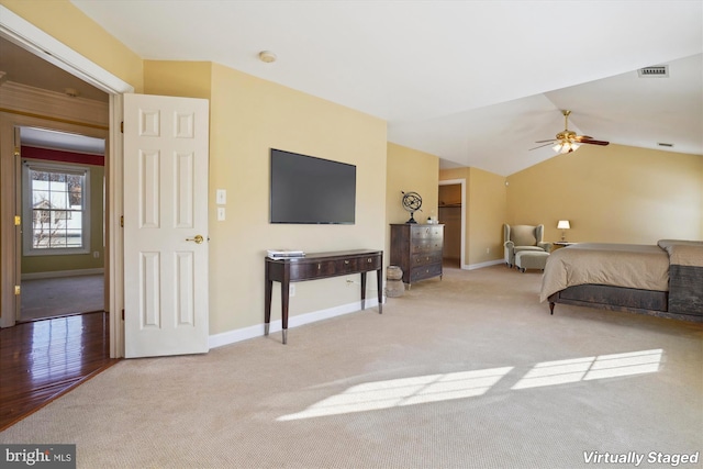 bedroom featuring ceiling fan, lofted ceiling, and light carpet