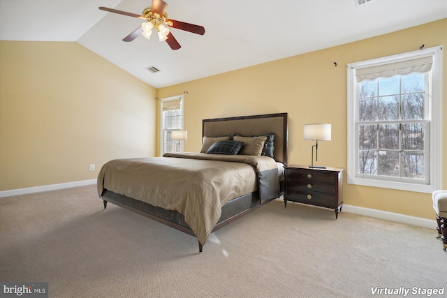 carpeted bedroom with ceiling fan and lofted ceiling