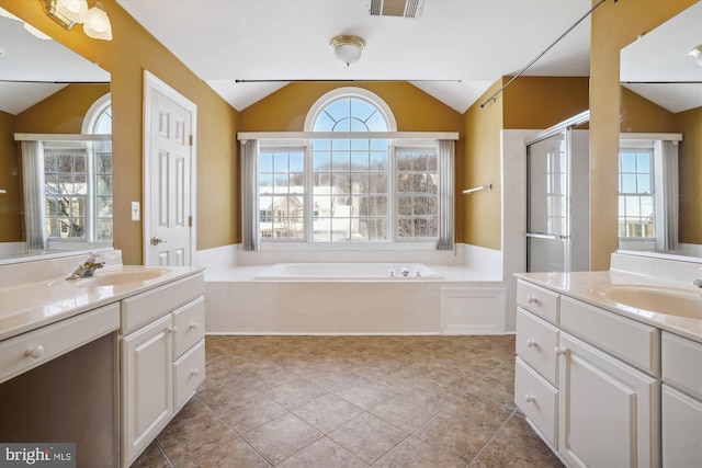 bathroom with plus walk in shower, a healthy amount of sunlight, and lofted ceiling