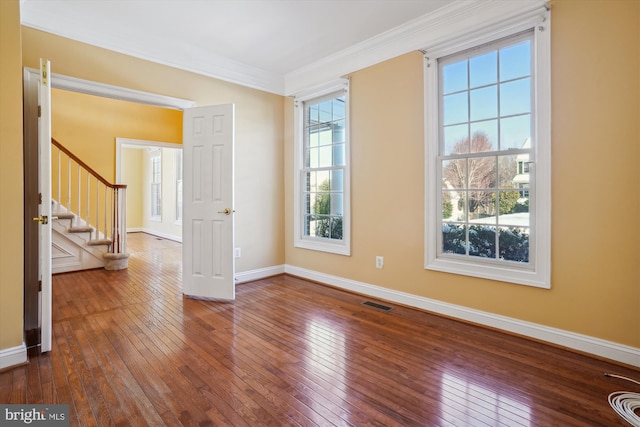 unfurnished room featuring crown molding, hardwood / wood-style floors, and plenty of natural light