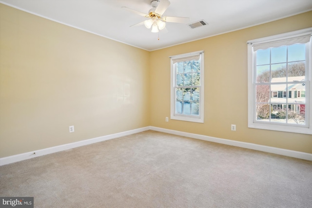 carpeted spare room with ceiling fan