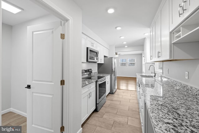 kitchen featuring light stone counters, white cabinets, and appliances with stainless steel finishes