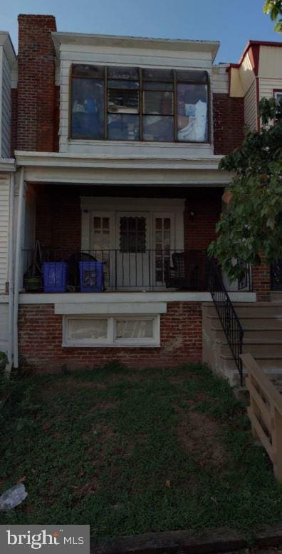 rear view of property featuring a porch