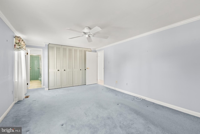 unfurnished bedroom with ceiling fan, crown molding, and carpet floors