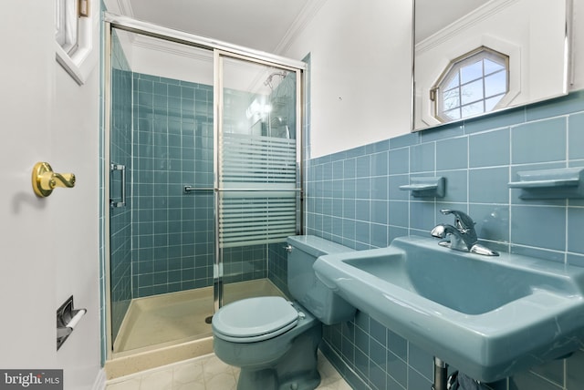 bathroom featuring toilet, crown molding, tile walls, sink, and an enclosed shower