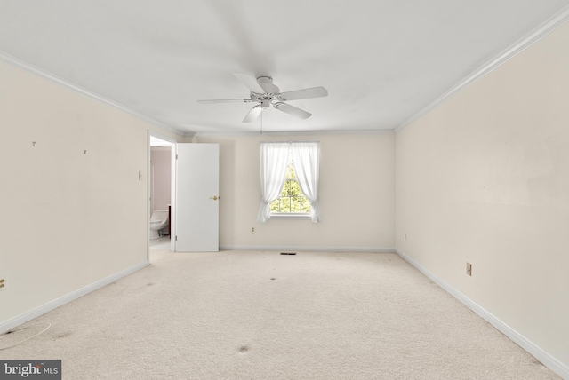 unfurnished room featuring ornamental molding, ceiling fan, and light colored carpet