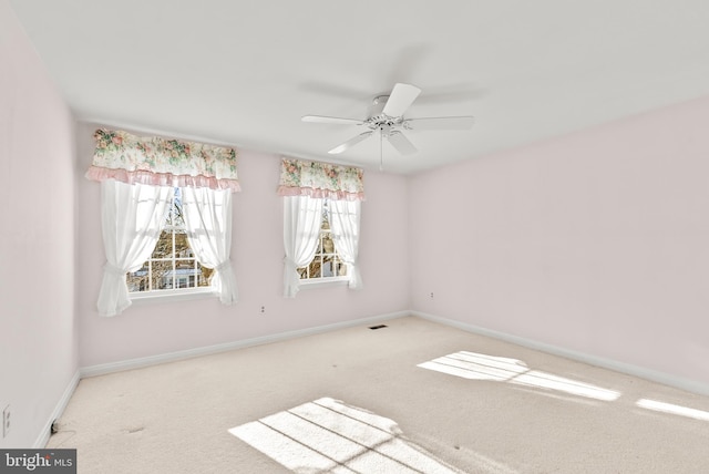 unfurnished room with ceiling fan and light carpet