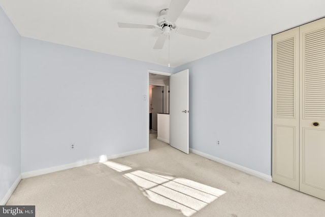 unfurnished bedroom featuring a closet, light carpet, and ceiling fan