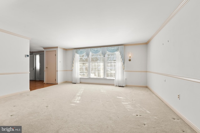 carpeted spare room featuring crown molding