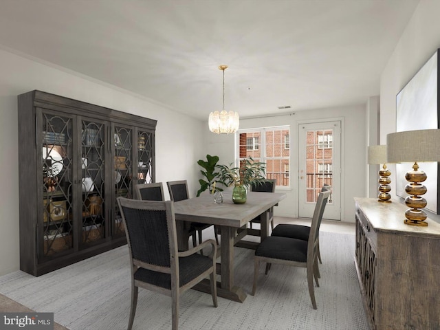 dining space featuring a chandelier and visible vents