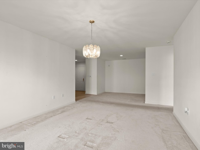 carpeted empty room featuring baseboards