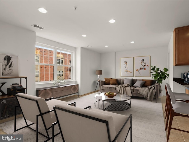 living room featuring recessed lighting and visible vents