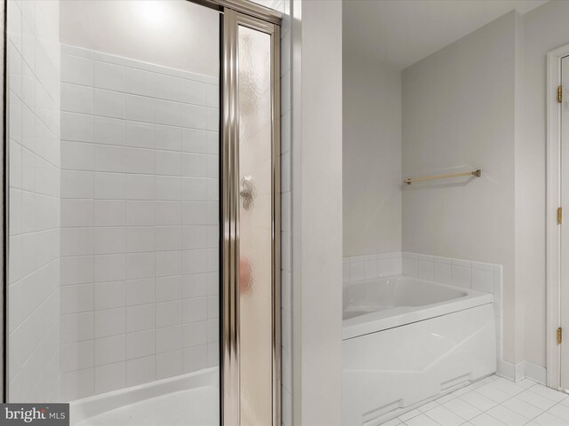 full bath with tile patterned floors, a stall shower, baseboards, and a garden tub