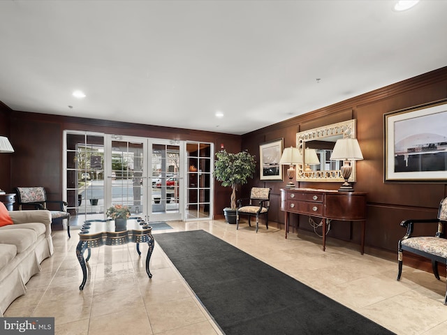 tiled living area with recessed lighting, french doors, and crown molding