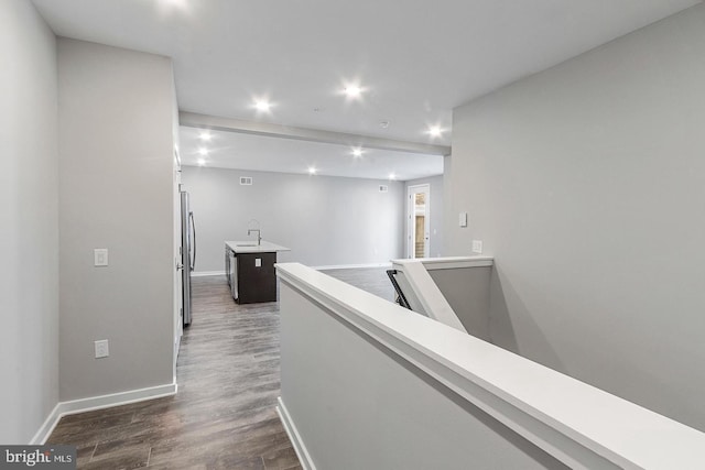 hallway featuring dark hardwood / wood-style floors and sink