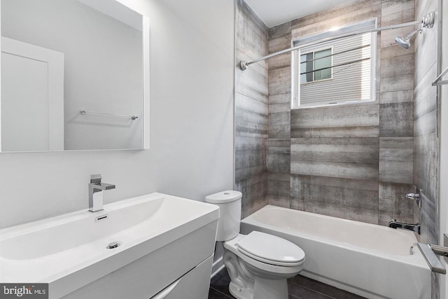 full bathroom with tile patterned flooring, tiled shower / bath combo, toilet, and vanity