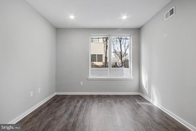 unfurnished room featuring dark hardwood / wood-style flooring