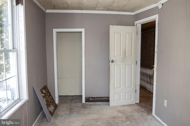 unfurnished bedroom featuring light colored carpet and ornamental molding