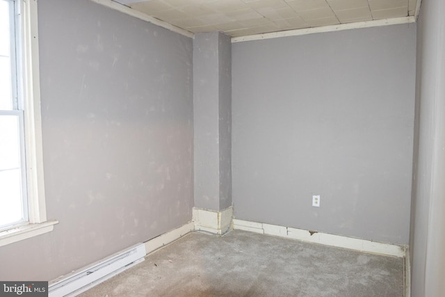 unfurnished room with a baseboard heating unit