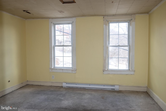 empty room featuring carpet floors and a baseboard heating unit