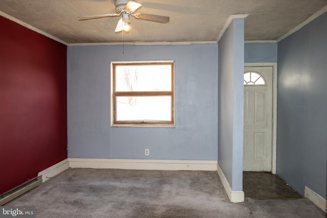 carpeted entrance foyer featuring a textured ceiling, ceiling fan, and ornamental molding