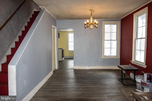 dining room featuring a notable chandelier, dark hardwood / wood-style floors, crown molding, and a baseboard heating unit