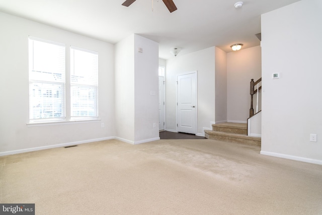 unfurnished living room with carpet flooring and ceiling fan