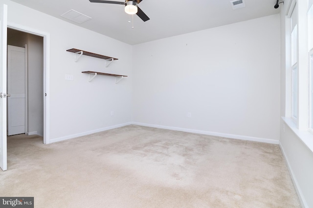 unfurnished room featuring ceiling fan and light colored carpet