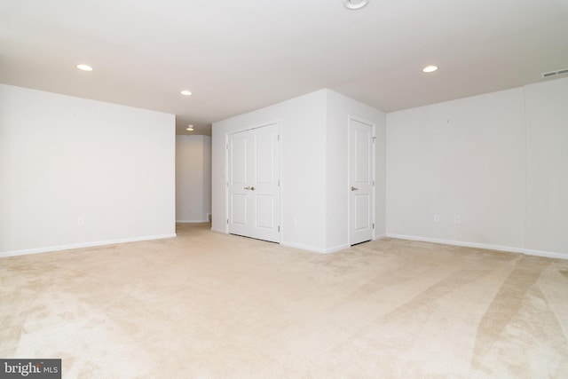 basement featuring light carpet