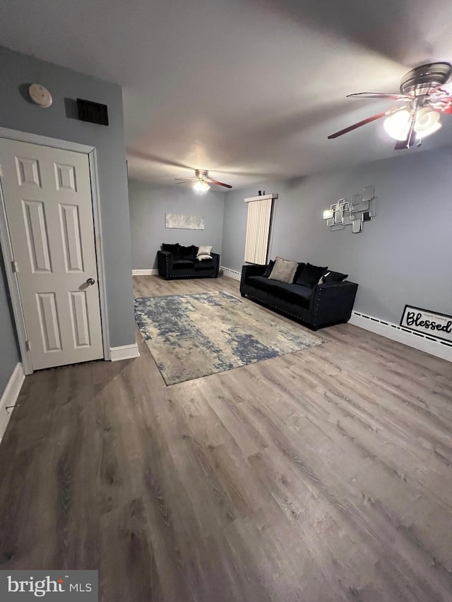 unfurnished living room featuring hardwood / wood-style flooring and ceiling fan