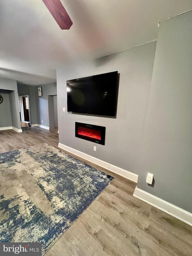 living room with hardwood / wood-style floors and ceiling fan