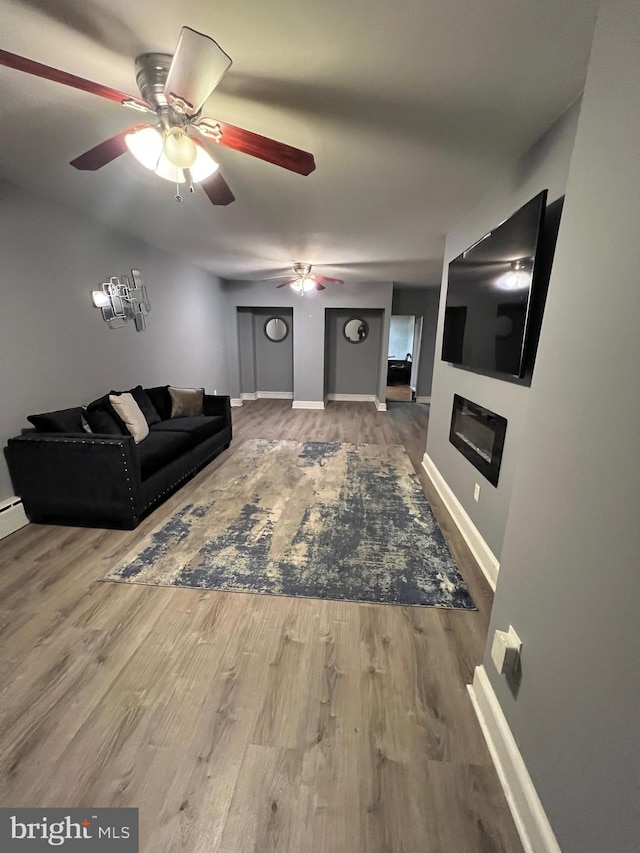 living room featuring ceiling fan and hardwood / wood-style floors