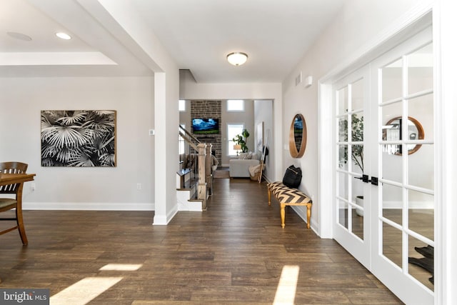 foyer featuring dark wood-type flooring and french doors