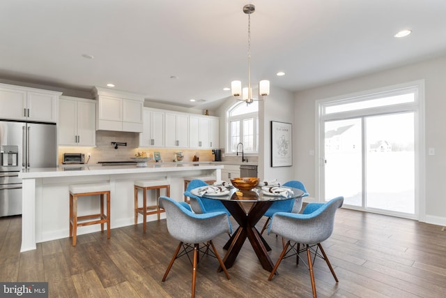 dining room with a chandelier, dark hardwood / wood-style flooring, and sink