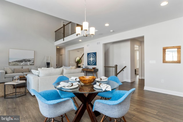 dining space featuring dark hardwood / wood-style floors and a notable chandelier