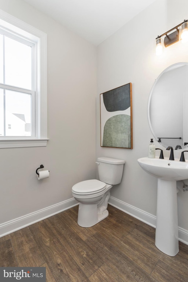 bathroom with sink, hardwood / wood-style floors, and toilet